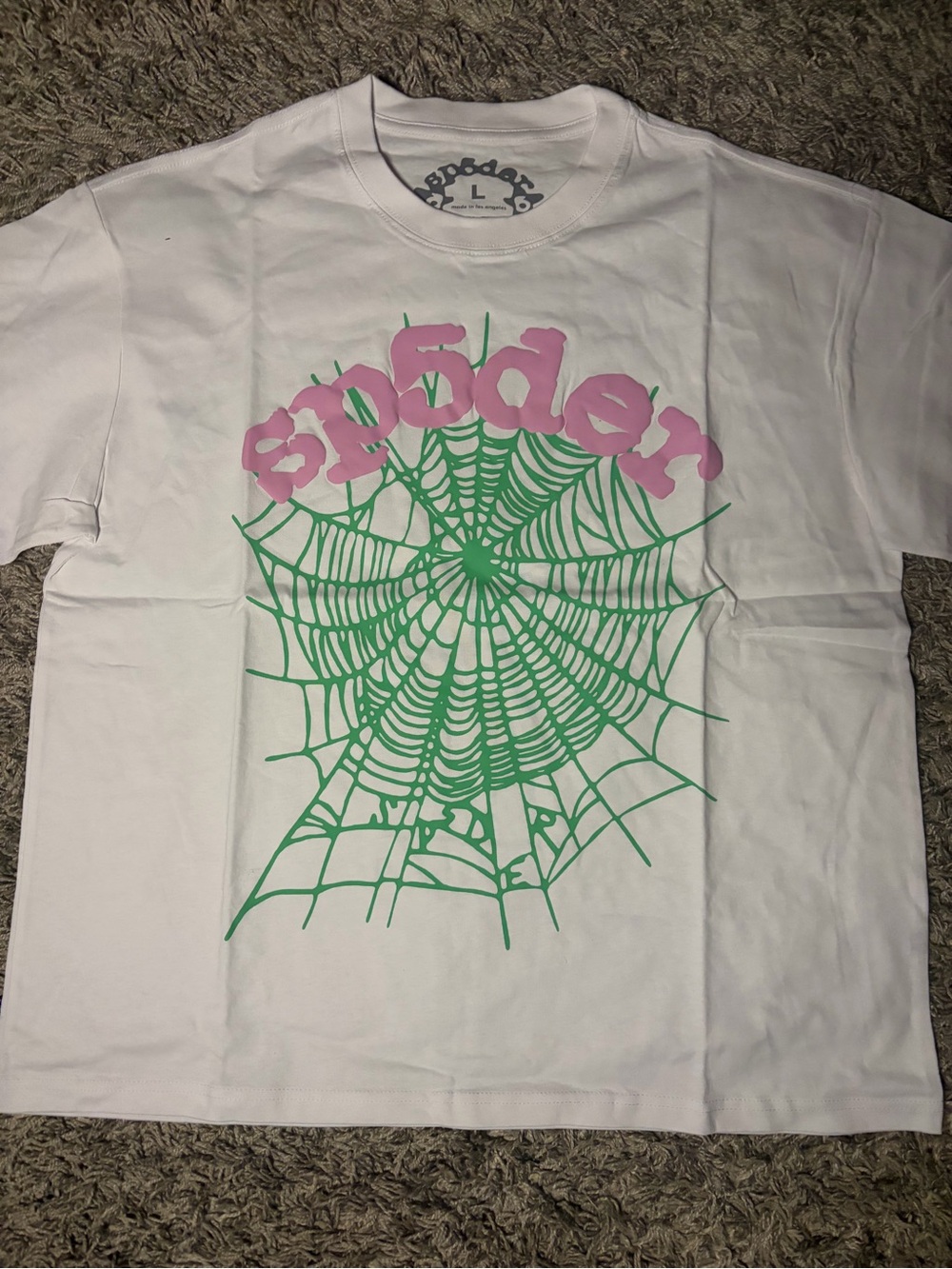 White Short-Sleeve Graphic Tee with Pink Logo and Green Spiderweb